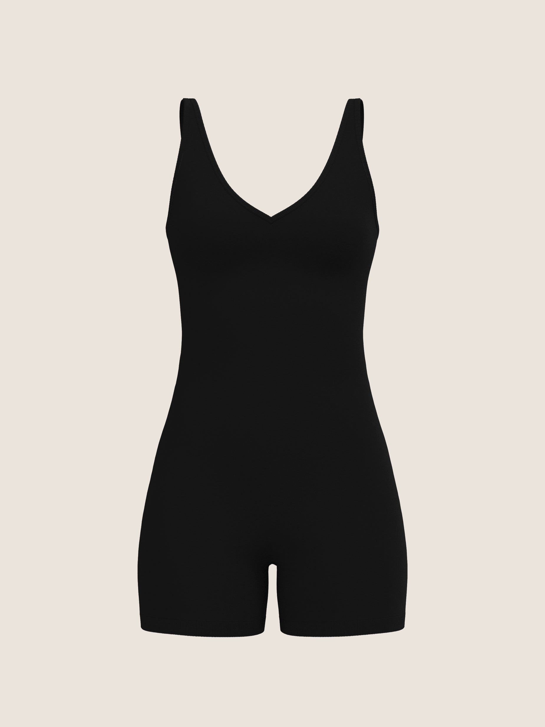 Black bodysuit on a beige background